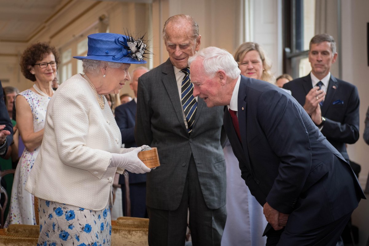 Governor General David Johnston of Canada presents a sapphire and diamond brooch to Queen Elizabeth II during her visit to Canada House in London to celebrate Canada's 150th anniversary of Confederation on July 19, 2017 (Stefan Rousseau/PA Images/Alamy)