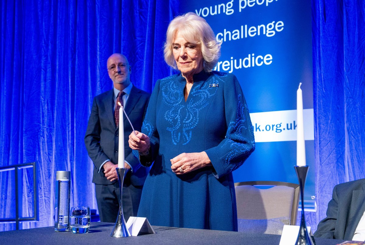 Queen Camilla lights a candle during a reception hosted by the Anne Frank Trust UK to mark Holocaust Memorial Day at the London Hilton, Park Lane on January 23, 2025 (Arthur Edwards/PA Images/Alamy)