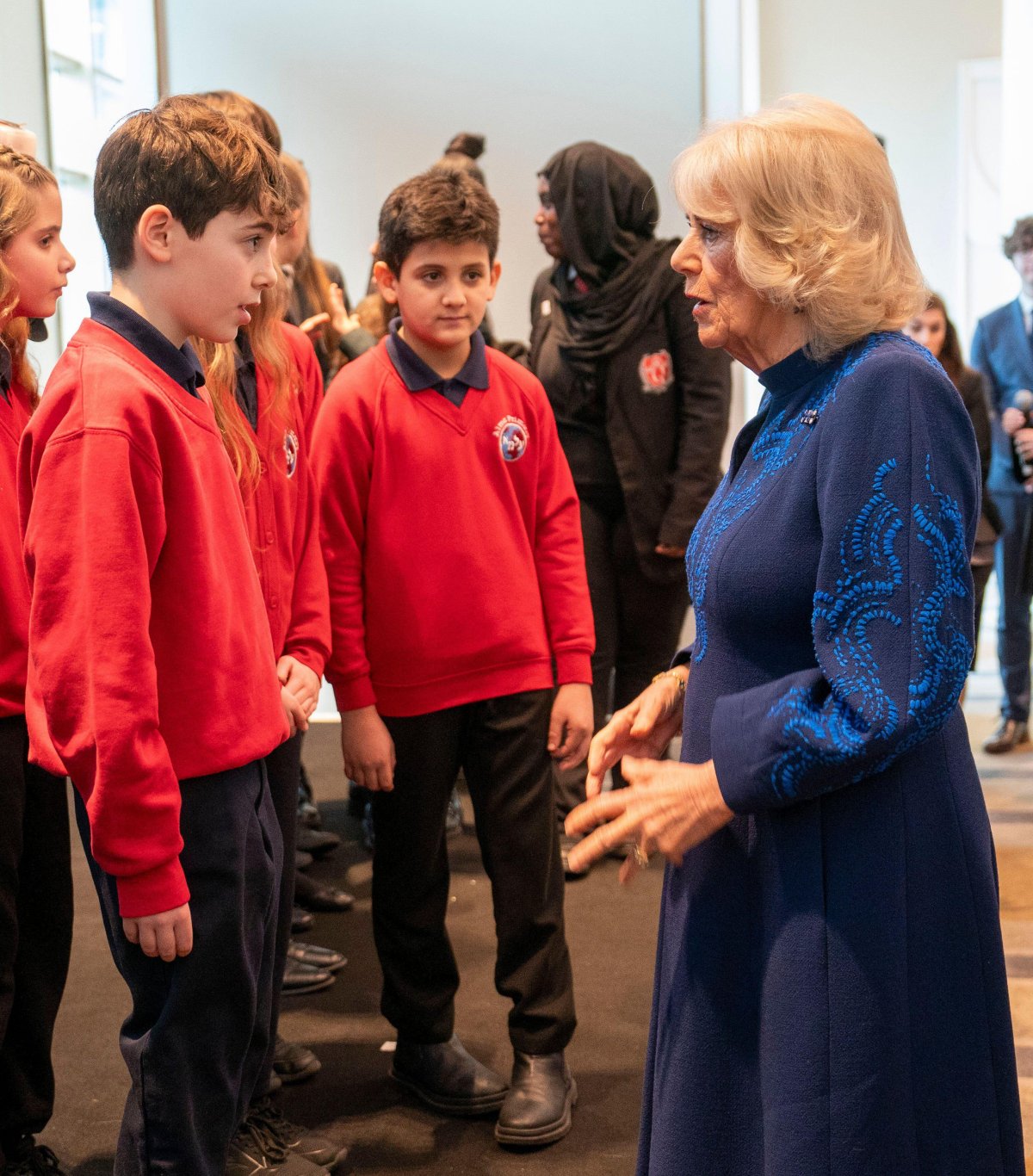 Queen Camilla speaks with schoolchildren during a reception hosted by the Anne Frank Trust UK to mark Holocaust Memorial Day at the London Hilton, Park Lane on January 23, 2025 (Arthur Edwards/PA Images/Alamy)