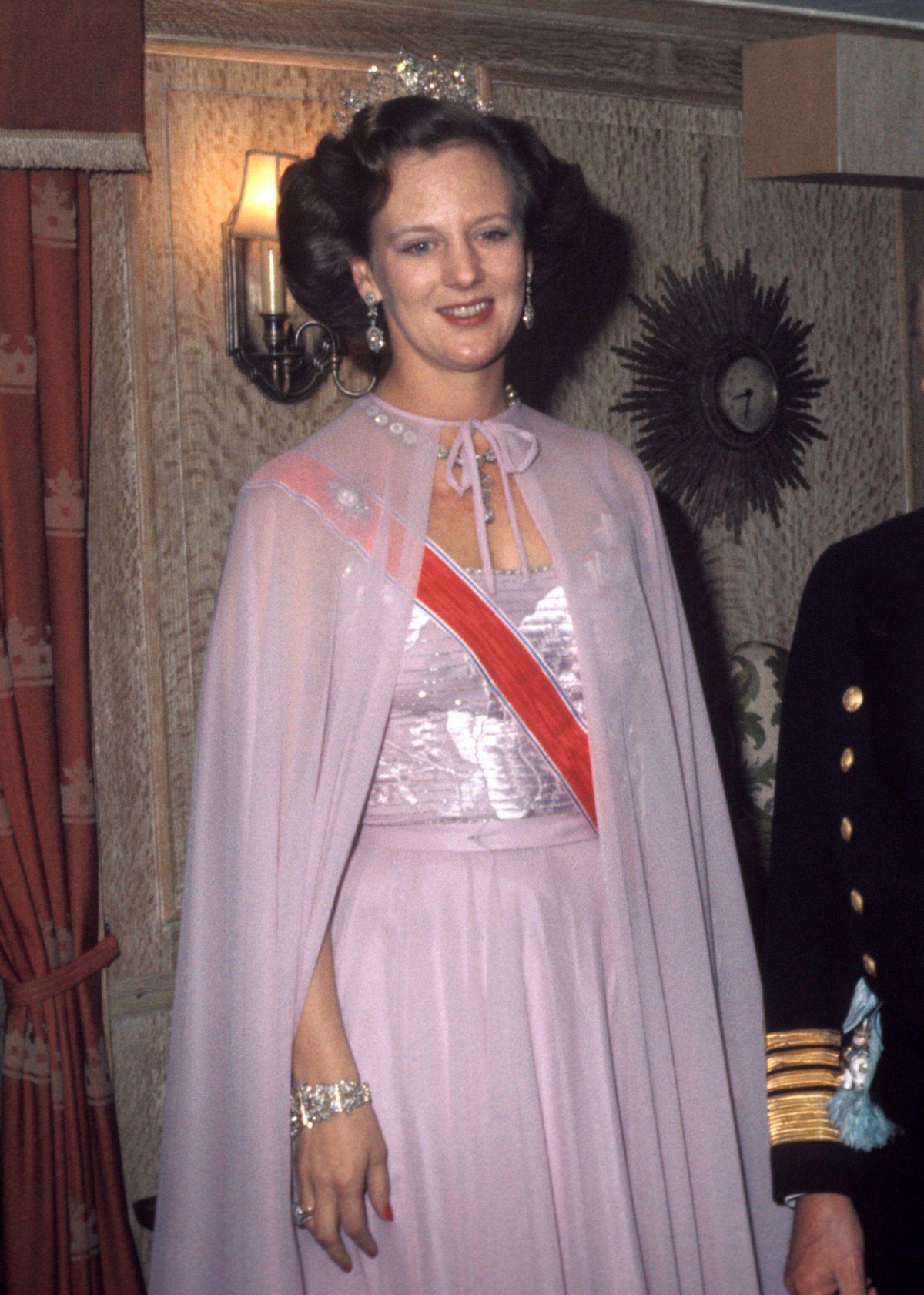 Queen Margrethe II of Denmark attends a dinner hosted by King Olav V of Norway during his official visit to Copenhagen, 1974 (Erik Thorberg/NTB/Alamy)