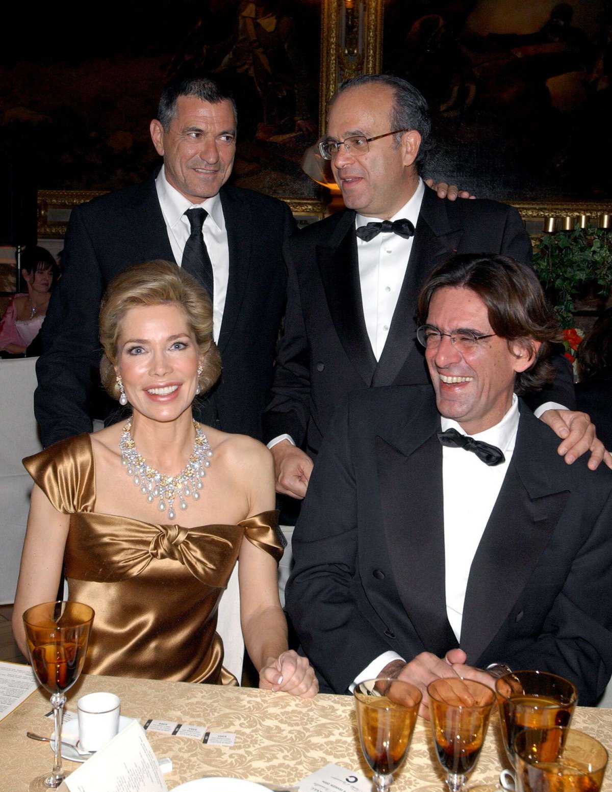 Begum Inaara Aga Khan, with French Education Minister Luc Ferry, French humorist Jean-Marie Bigard, and Professor David Khayat, attends a charity gala dinner supporting cancer research funding at the Palace of Versailles on February 9, 2004 (Serge Arnal/Abaca Press/Alamy)