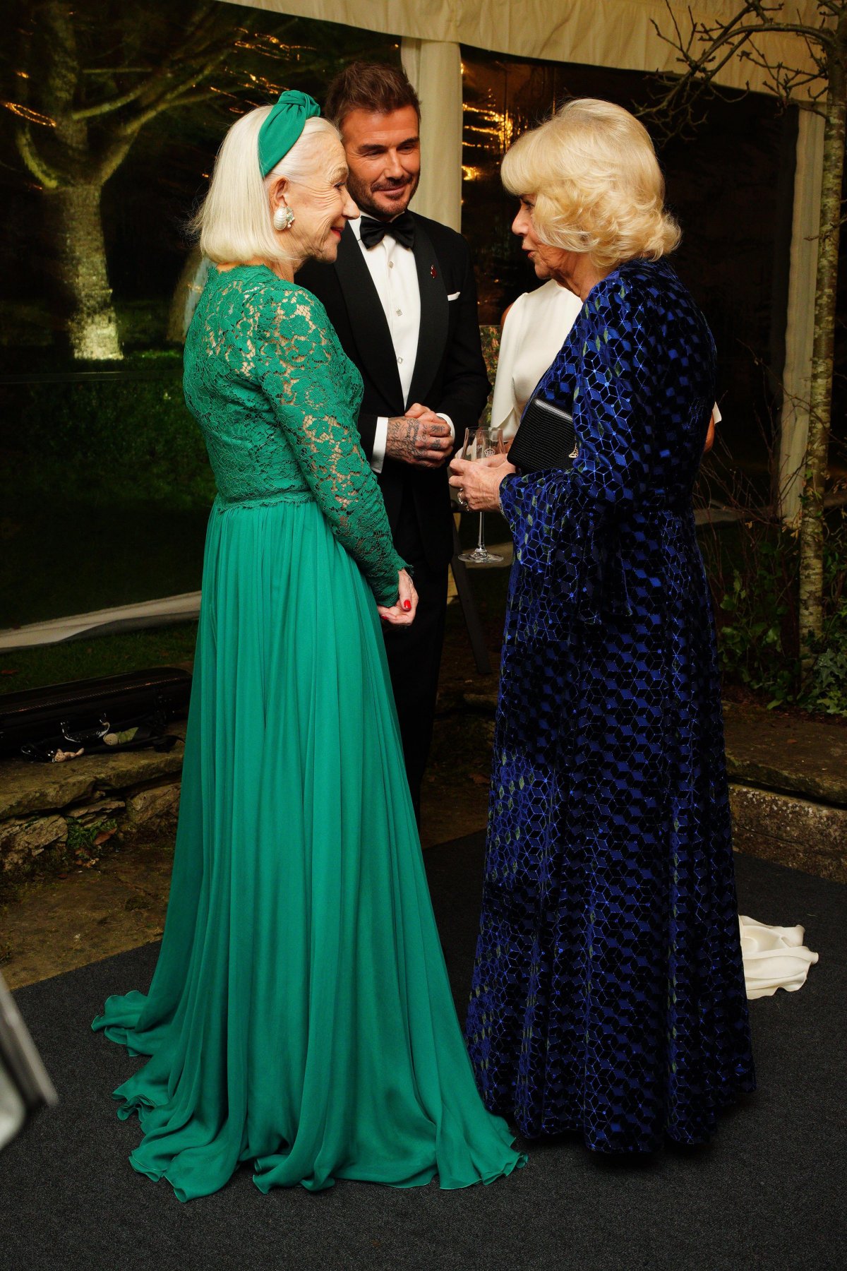 Queen Camilla greets Dame Helen Mirren and David and Victoria Beckham at a dinner in celebration of Slow Food at King Charles III's Gloucestershire estate, Highgrove House, on February 7, 2025 (Ben Birchall/PA Images/Alamy)