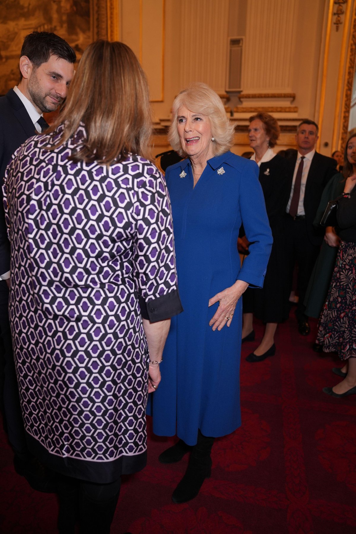 Queen Camilla hosts a reception celebrating exceptional individuals and organizations contributing towards humanitarian efforts across the globe at Buckingham Palace in London on February 20, 2025 (Yui Mok/PA Images/Alamy)