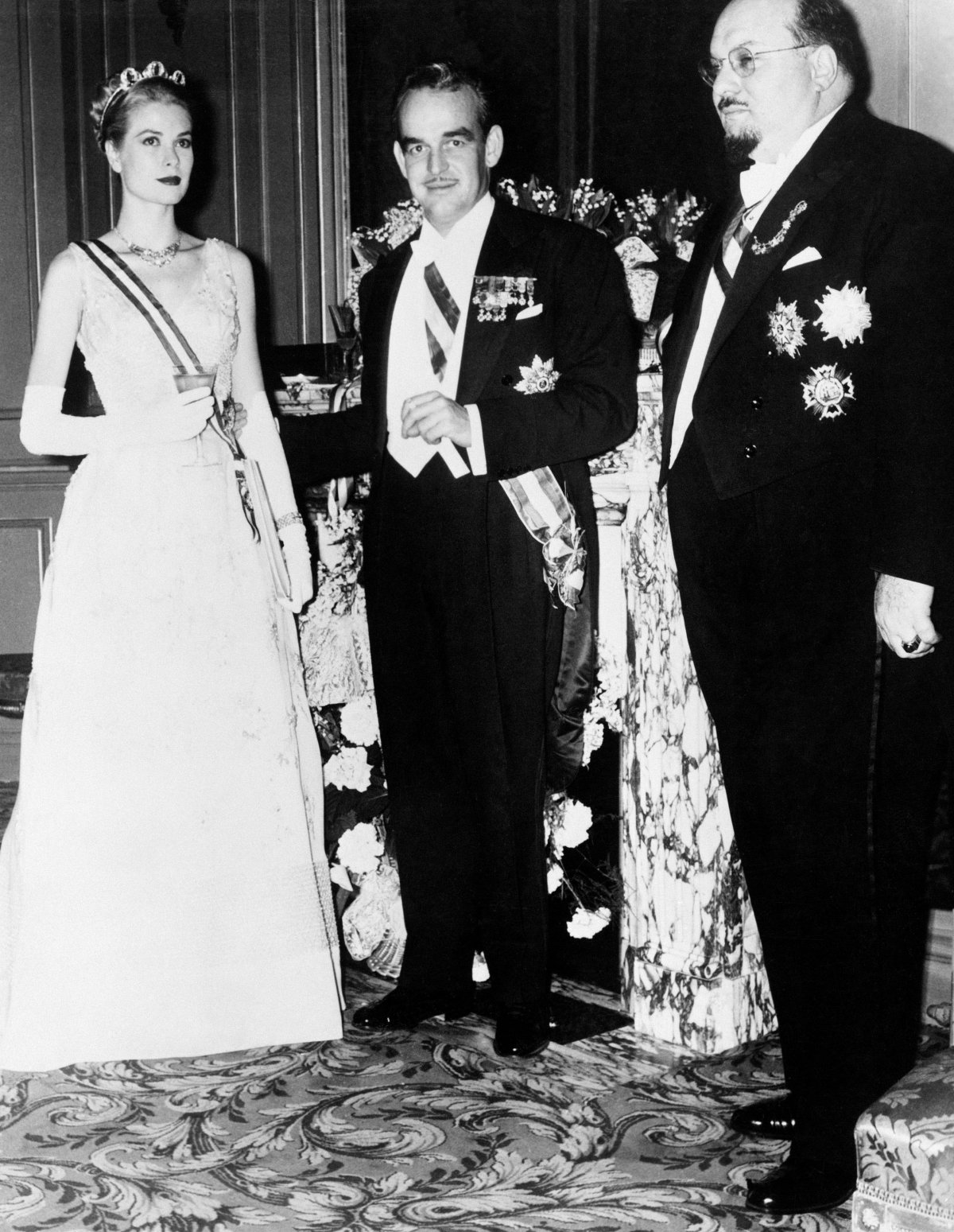 Grace Kelly, Prince Rainier III of Monaco, and King Farouk of Egypt are pictured during a reception at the Opera in Monte-Carlo on the eve of Rainier and Grace's royal wedding, April 1956 (Pictorial Press Ltd/Alamy)