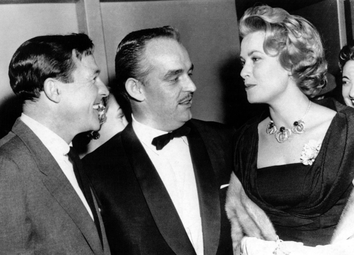 Gene Kelly speaks with Prince Rainier III and Princess Grace of Monaco at a production of Flower Drum Song in New York, December 1958 (Everett Collection/Alamy)