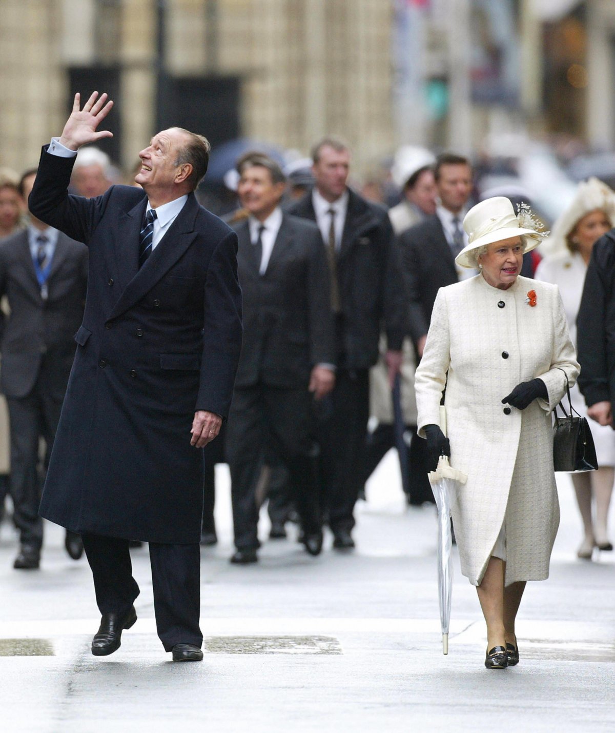Queen Elizabeth II walks with President Jacques Chirac in Paris during a state visit to France on April 5, 2004 (THOMAS COEX/AFP via Getty Images)