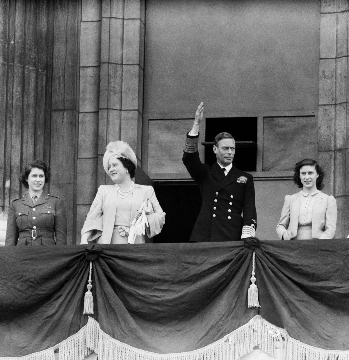 King George VI and Queen Elizabeth, with Princess Elizabeth and Princess Margaret, wave from the balcony of Buckingham Palace on VE Day, May 8, 1945 (Trinity Mirror/Mirrorpix/Alamy)