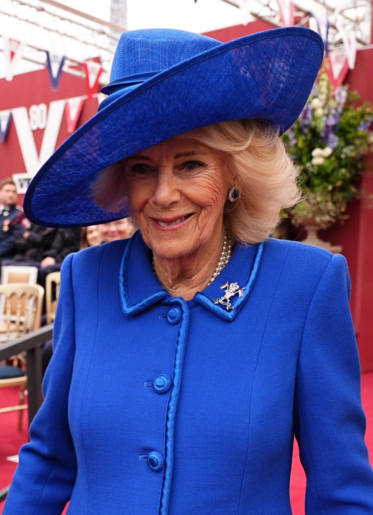 Queen Camilla arrives for the military procession for the 80th anniversary of VE Day, in honor of those who served during the Second World War, at Buckingham Palace in London on May 5, 2025 (Aaron Chown/PA Images/Alamy)
