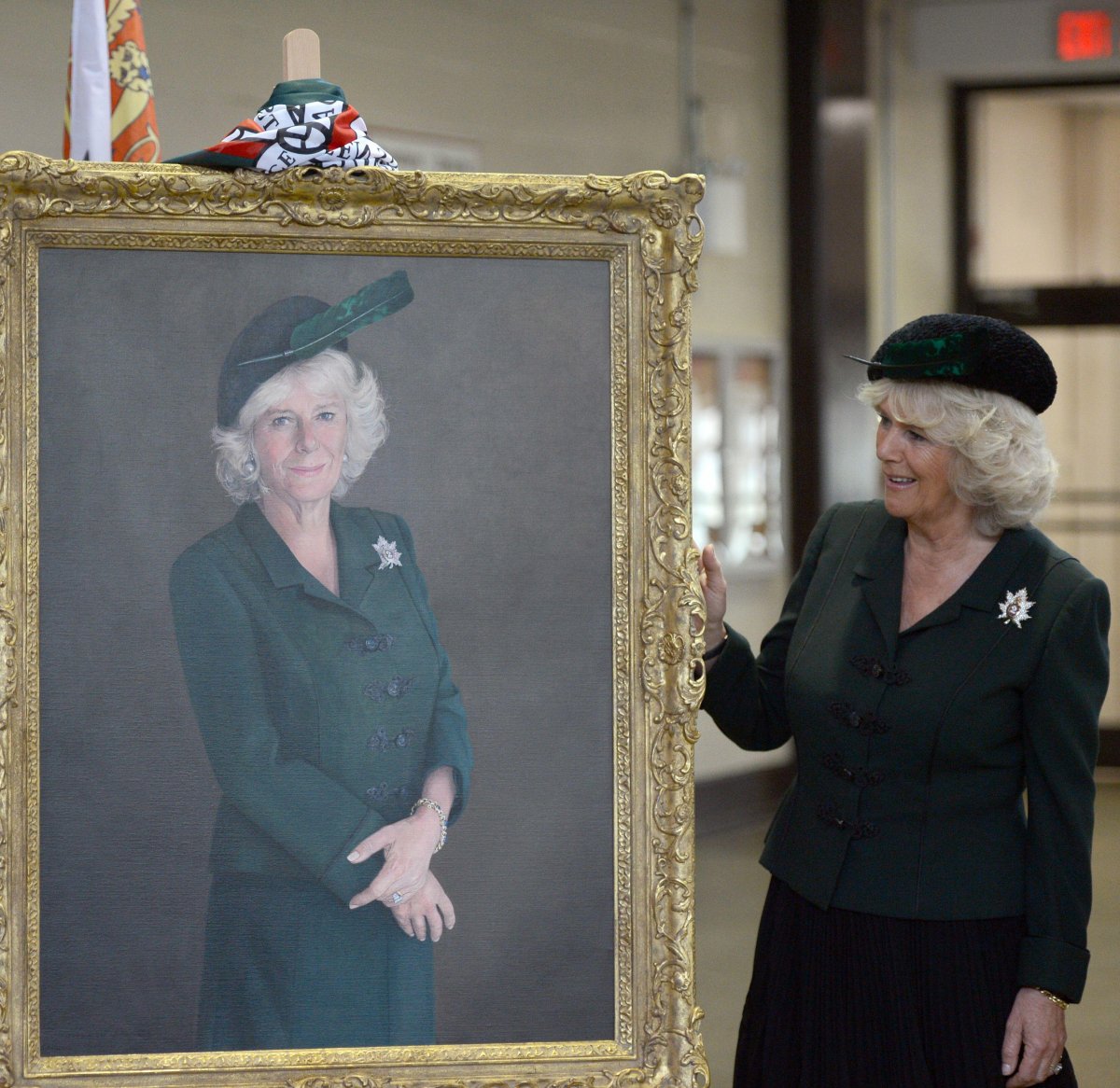 The Duchess of Cornwall unveils a portrait during a visit with the Queen's Own Rifles of Canada regiment at Moss Park Armoury in Toronto on May 22, 2012 (Anwar Hussein/Alamy)