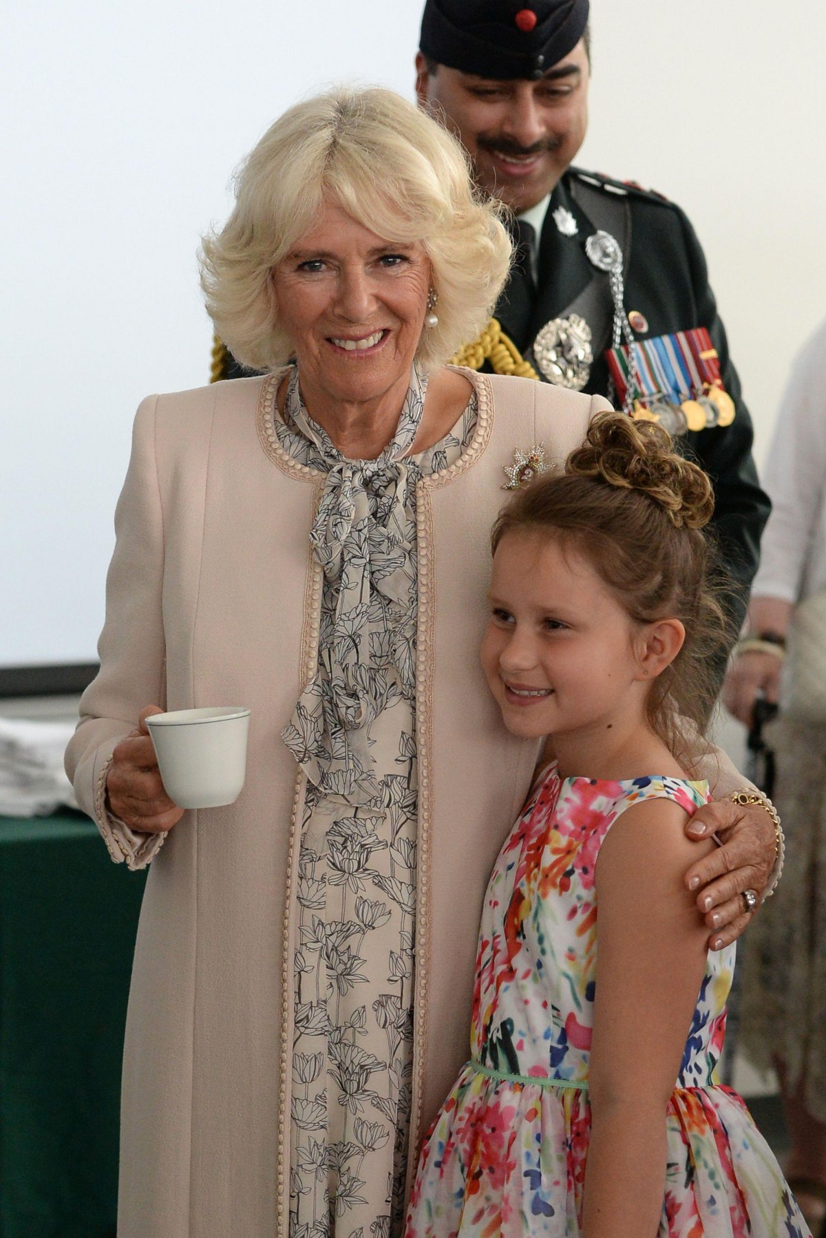 The Duchess of Cornwall embraces Georgia Pampe during a visit to the Canadian Army Advanced Warfare Centre at Canadian Forces Base Trenton in Quinte West, Ontario, on June 30, 2017 (Joe Giddens/PA Images/Alamy)