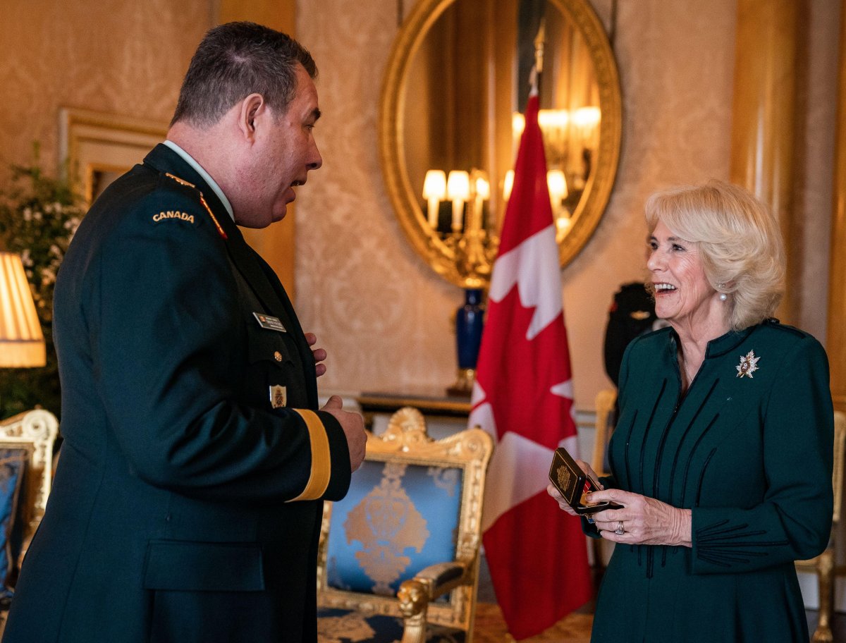 Brigadier-General Dwayne Parsons presents the Canadian Forces' Decoration to Queen Camilla during a reception for the Queen's Own Rifles of Canada at Buckingham Palace in London on February 1, 2023 (Aaron Chown/PA Images/Alamy)