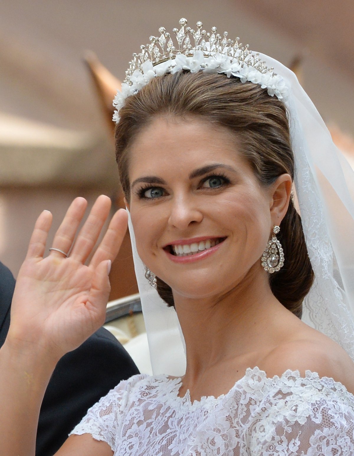 Princess Madeleine of Sweden waves from a carriage after her royal wedding in Stockholm on June 8, 2013 (Torsten Laursen/Getty Images)