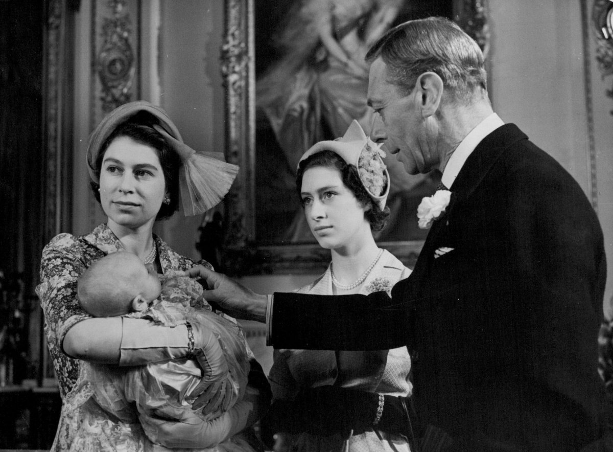 Princess Elizabeth (holding Princess Anne), Princess Margaret, and King George VI are photographed during the christening of the baby princess at Buckingham Palace in London on October 21, 1950 (SuperStock/Alamy)