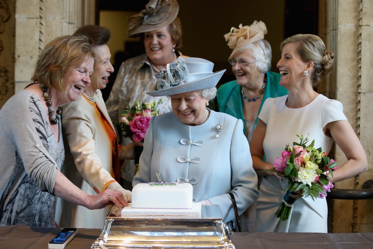 The Queen helps to cut a Women's Institute Celebrating 100 Years cake at the centenary annual meeting of the National Federation of Women's Institutes at the Royal Albert Hall in London on June 4, 2015 (Chris Jackson/PA Images/Alamy)