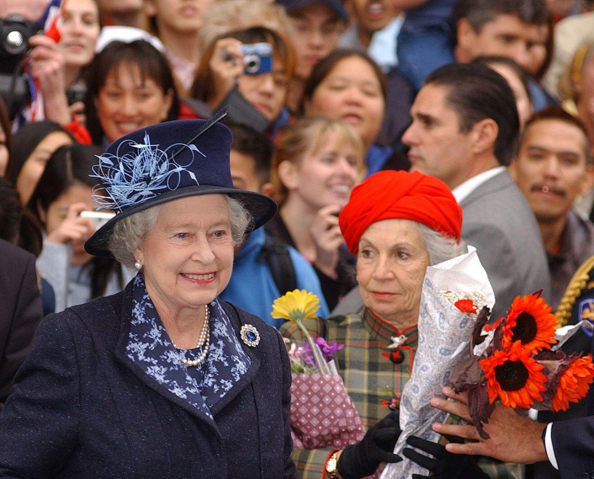 Queen Elizabeth II, with the Countess of Airlie following behind, greets locals during a walkabout at during a walkabout at the University of British Columbia on October 7, 2002 (Kirsty Wigglesworth/PA Images/Alamy)