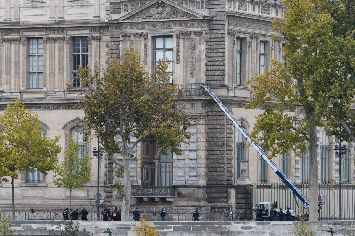 Investigators are pictured on the scene of a robbery at the Louvre Museum on October 19, 2025 (Florian Poitout/Abaca Press/Alamy)