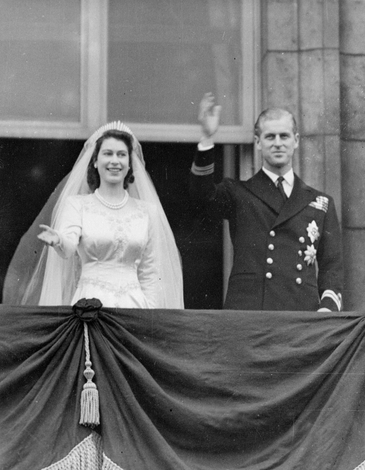 Princess Elizabeth and Prince Philip wave from the balcony of Buckingham Palace after their royal wedding on November 20, 1947 (Smith Archive/Alamy)
