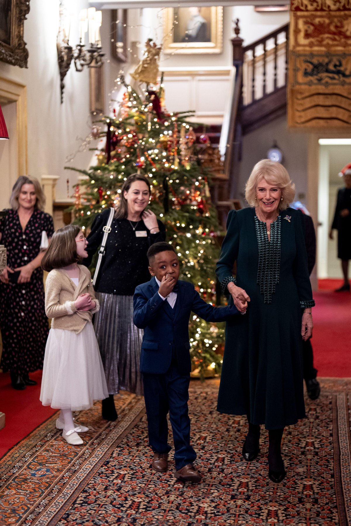 Queen Camilla hosts a Christmas tree decorating party for children from Helen and Douglas House and Roald Dahl's Marvellous Children's Charity at Clarence House in London on December 11, 2025 (Aaron Chown/PA Images/Alamy)
