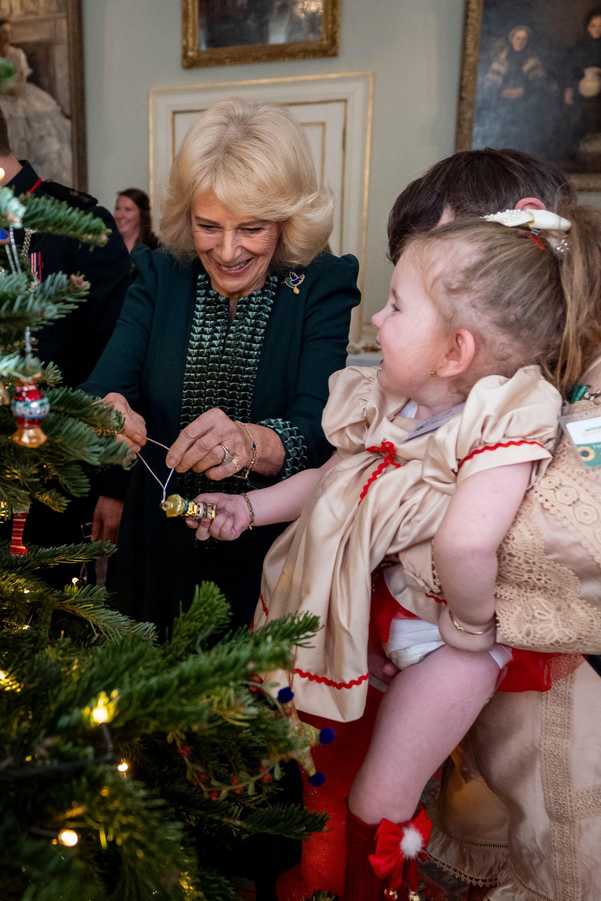 Queen Camilla hosts a Christmas tree decorating party for children from Helen and Douglas House and Roald Dahl's Marvellous Children's Charity at Clarence House in London on December 11, 2025 (Aaron Chown/PA Images/Alamy)