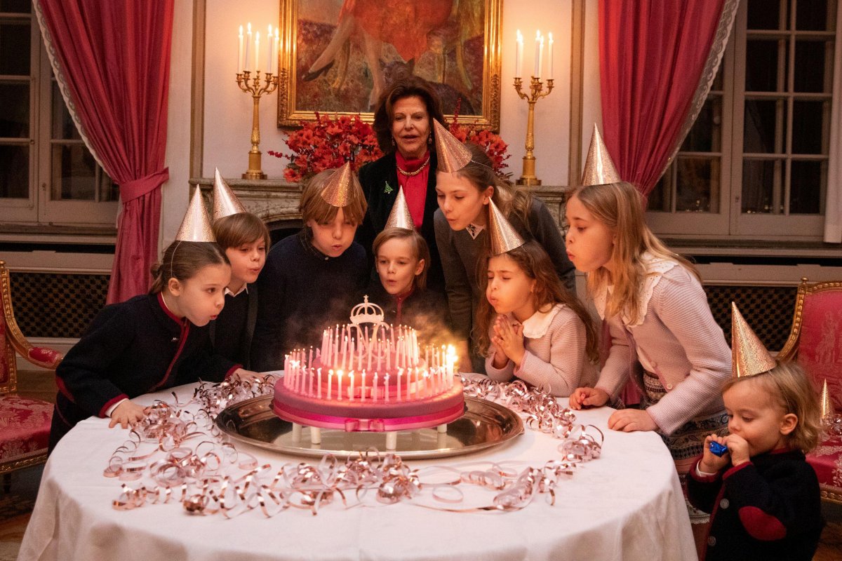 Queen Silvia's grandchildren blow out candles on a cake during her surprise birthday party in Stockholm on December 17, 2023 (Sara Friberg/Royal Court/Handout/TT News Agency)
