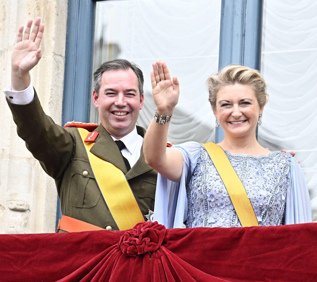 The Grand Duke and Grand Duchess of Luxembourg wave from the palace balcony on the day of his accession to the throne, October 3, 2025 (David Niviere/Abaca Press/Alamy)