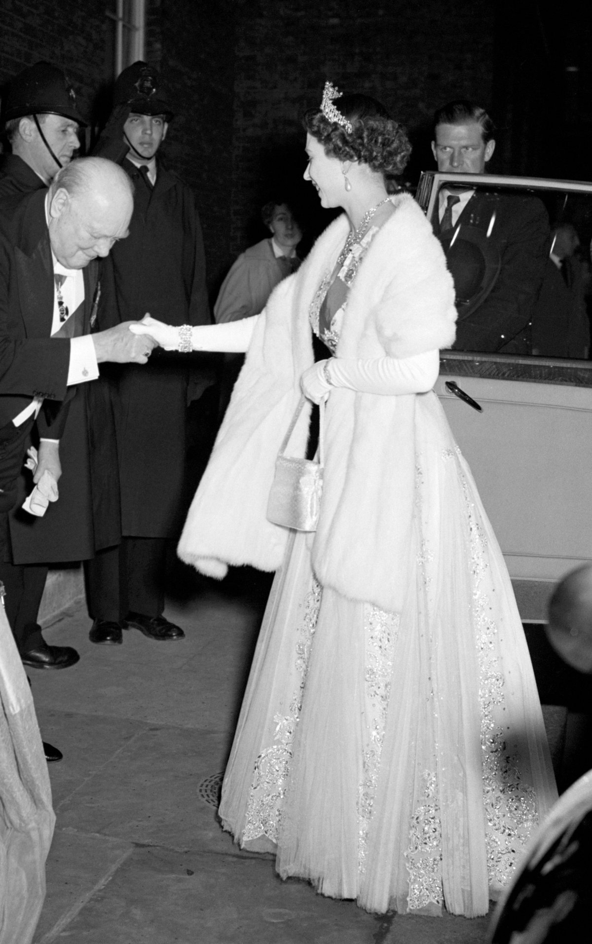 Queen Elizabeth II and the Duke of Edinburgh arrive for a dinner party given by Winston and Clementine Churchill at Downing Street in London on April 4, 1955 (PA Images/Alamy)