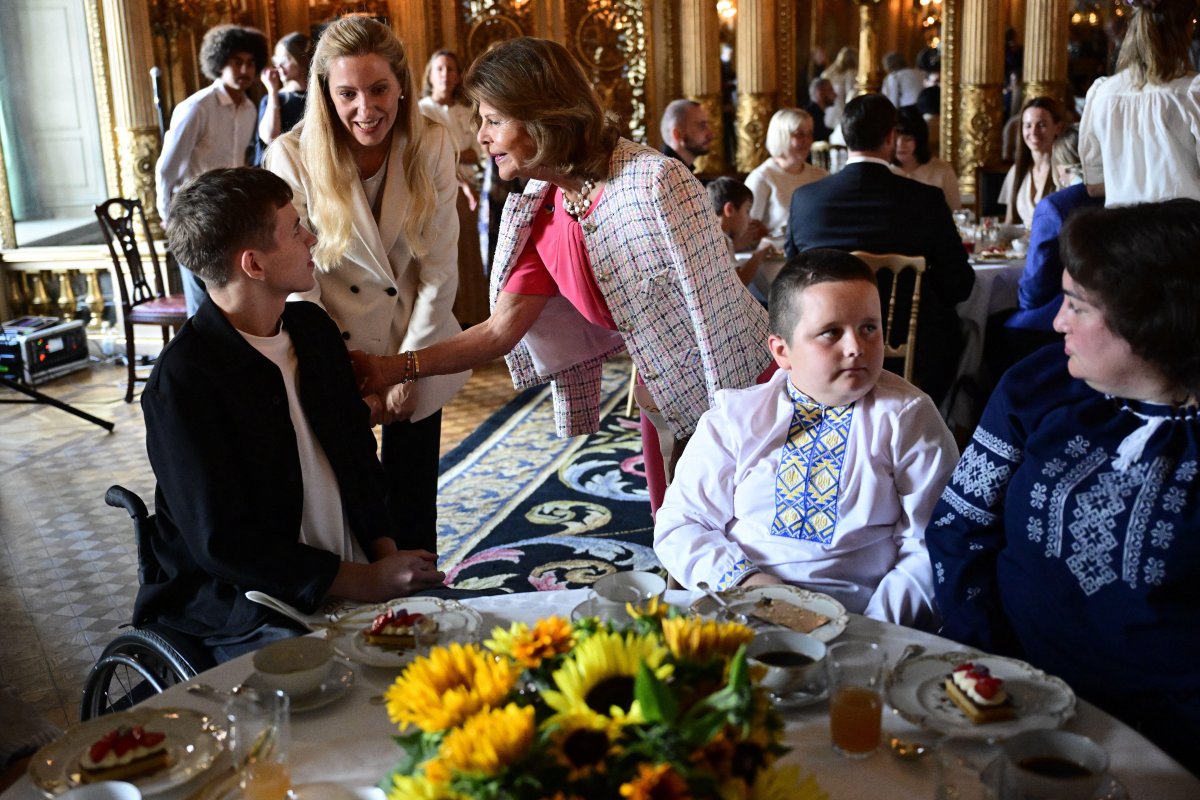 The Queen of Sweden, with Crown Princess Victoria and Princess Madeleine, welcomes war-wounded Ukrainian children to the Royal Palace in Stockholm on August 25, 2026 (Jonas Ekströmer/TT News Agency/Alamy)