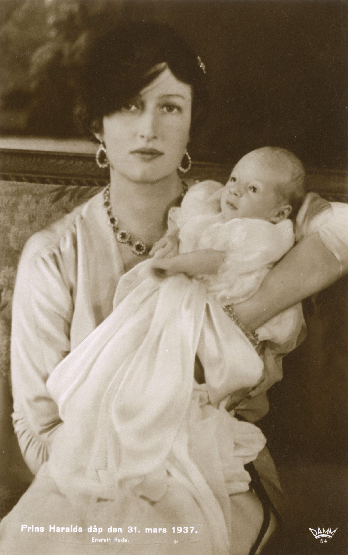 Crown Princess Märtha of Norway holds her son, Prince Harald, on his baptismal day at the Royal Palace in Oslo, March 31, 1937 (Chronicle/Alamy)